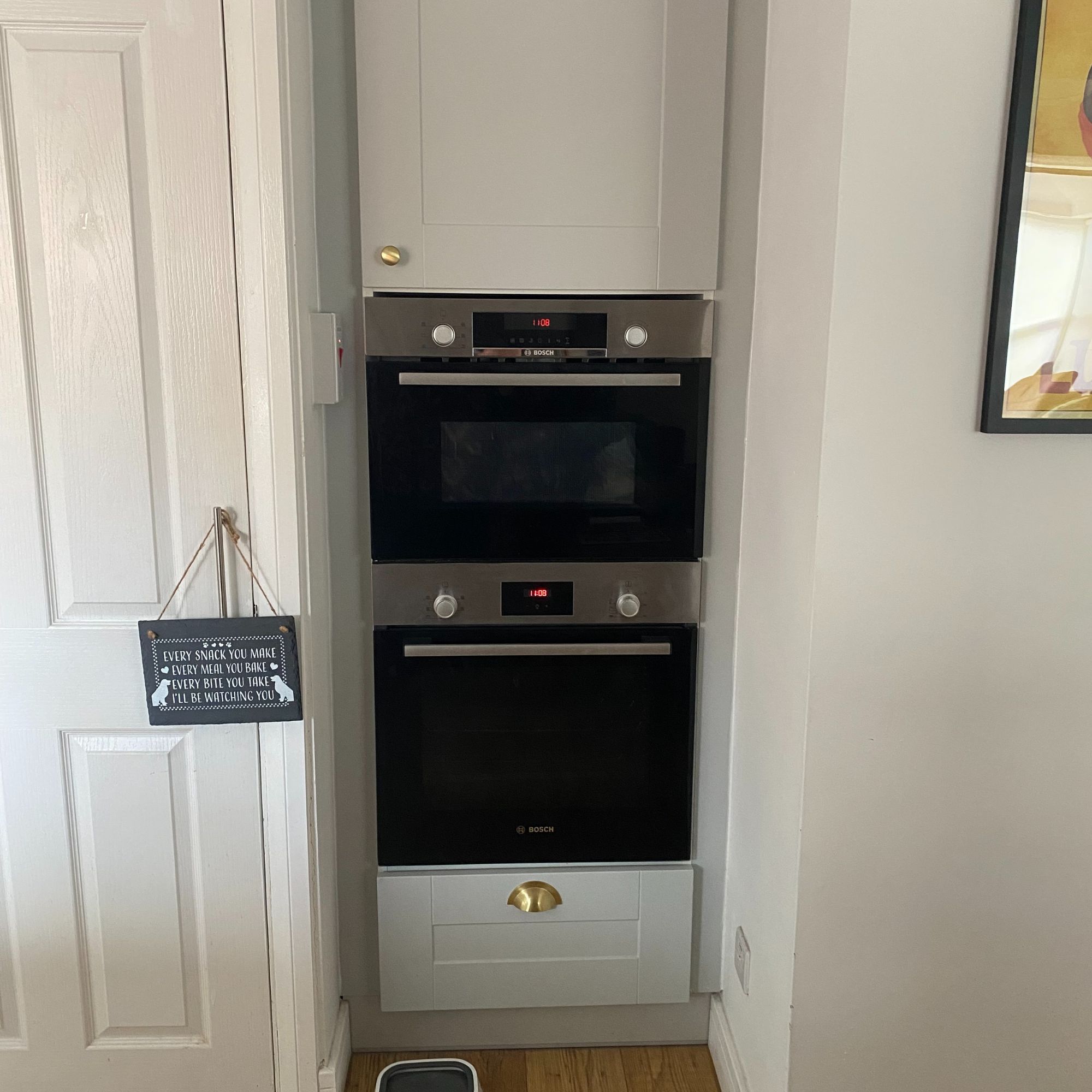 Built in oven with a cupboard above and a pull out drawer below
