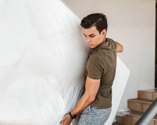 How to dispose of a mattress: Mattress being removed by man