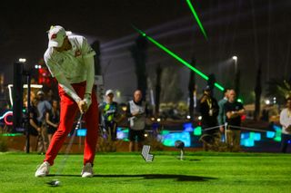 Sergio Garcia hits a shot at LIV Golf Riyadh 2025 in the dark with green strobe lights in the background