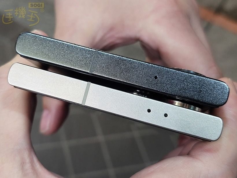 A person holding a sleek silver Galaxy S24 Ultra and black Galaxy S23 Ultra