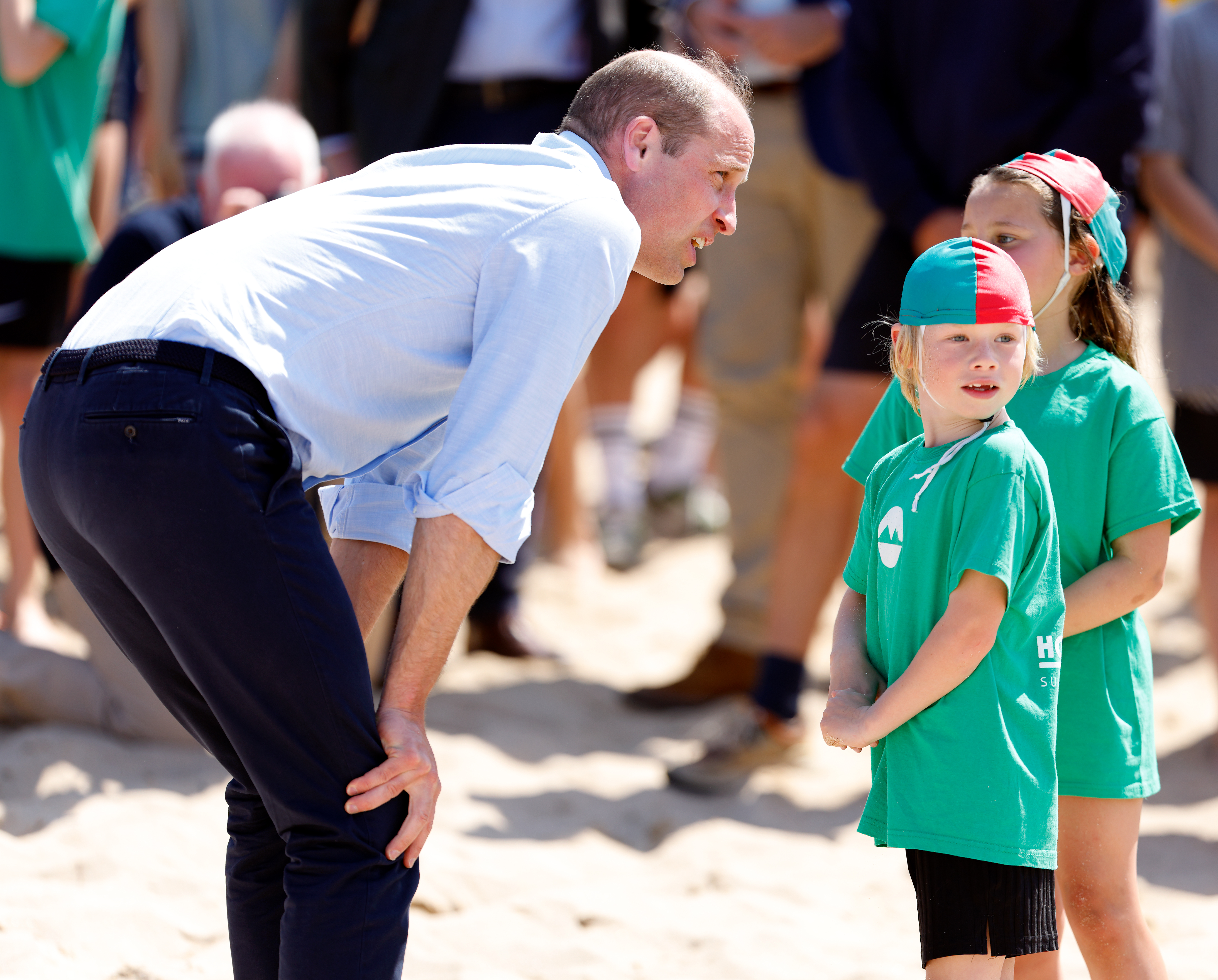 Prince William chats with children on the beach in Cornwall