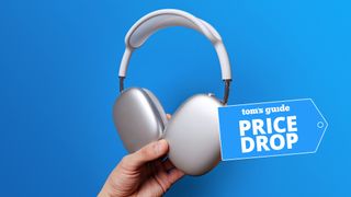 AirPods Max in hand with deal tag 