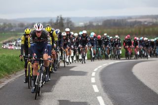 The pack of riders cycles during the 2nd stage of the Paris-Nice cycling race, 183,9 km between Montesson and Bellegarde, on March 10, 2025. (Photo by Anne-Christine POUJOULAT / AFP)