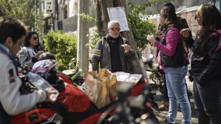 Paul Hollywood in a leather jacket and sunglasses samples Mexican fast food with female motorbike gang members from MC Orquideas in Paul Hollywood Eats Mexico.