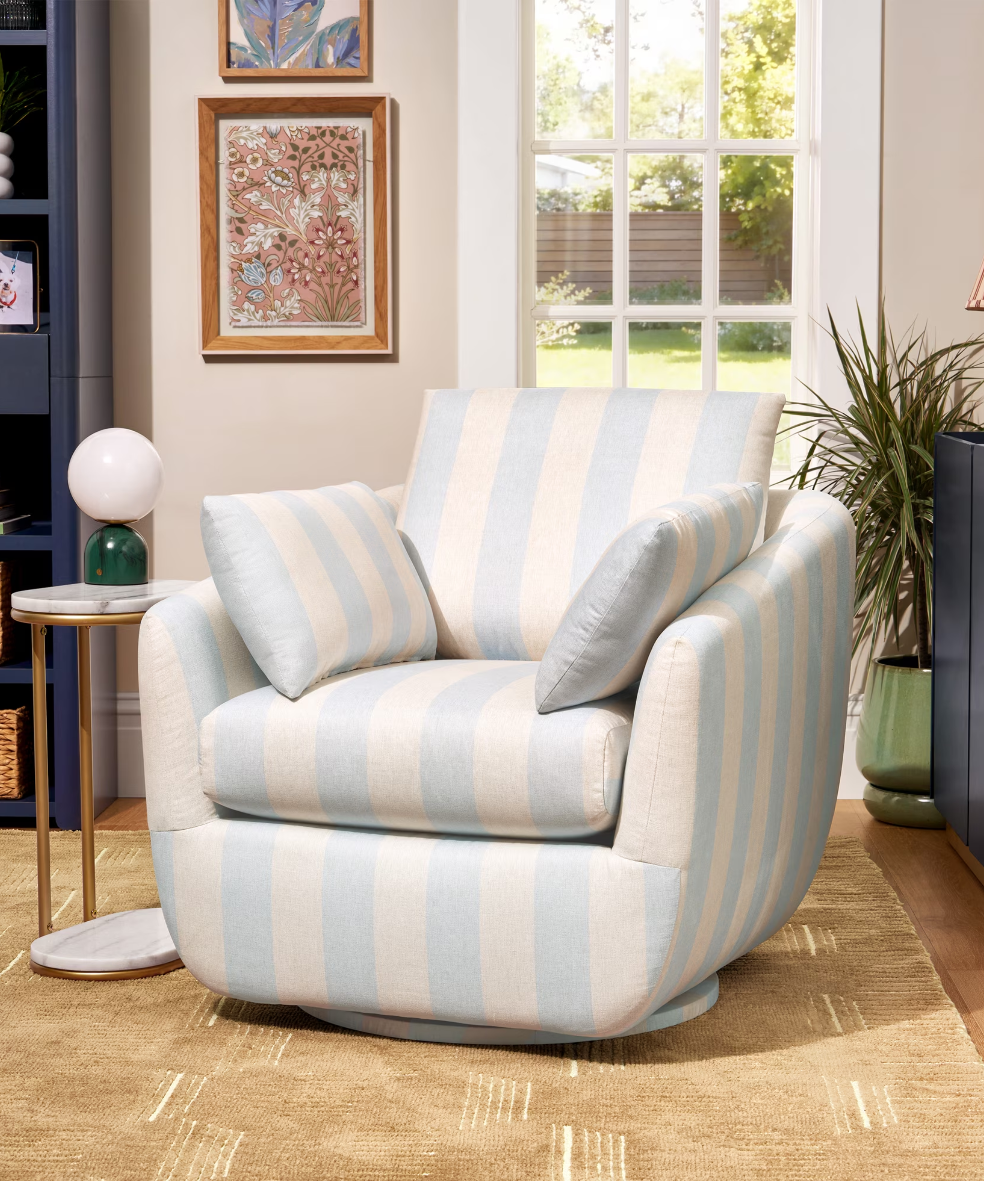 a blue and white striped swivel chair in a living room