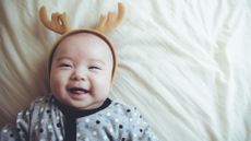 Christmas baby names illustrated by Baby with reindeer headband