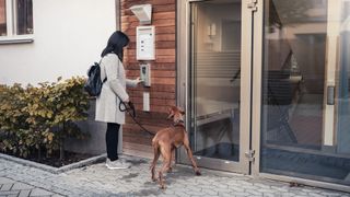 lady with dog at door to apartment