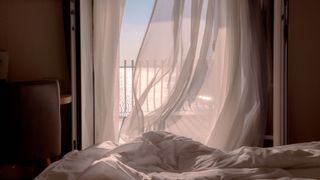 A large bedroom window open to allow a fresh breeze to circulate during the night