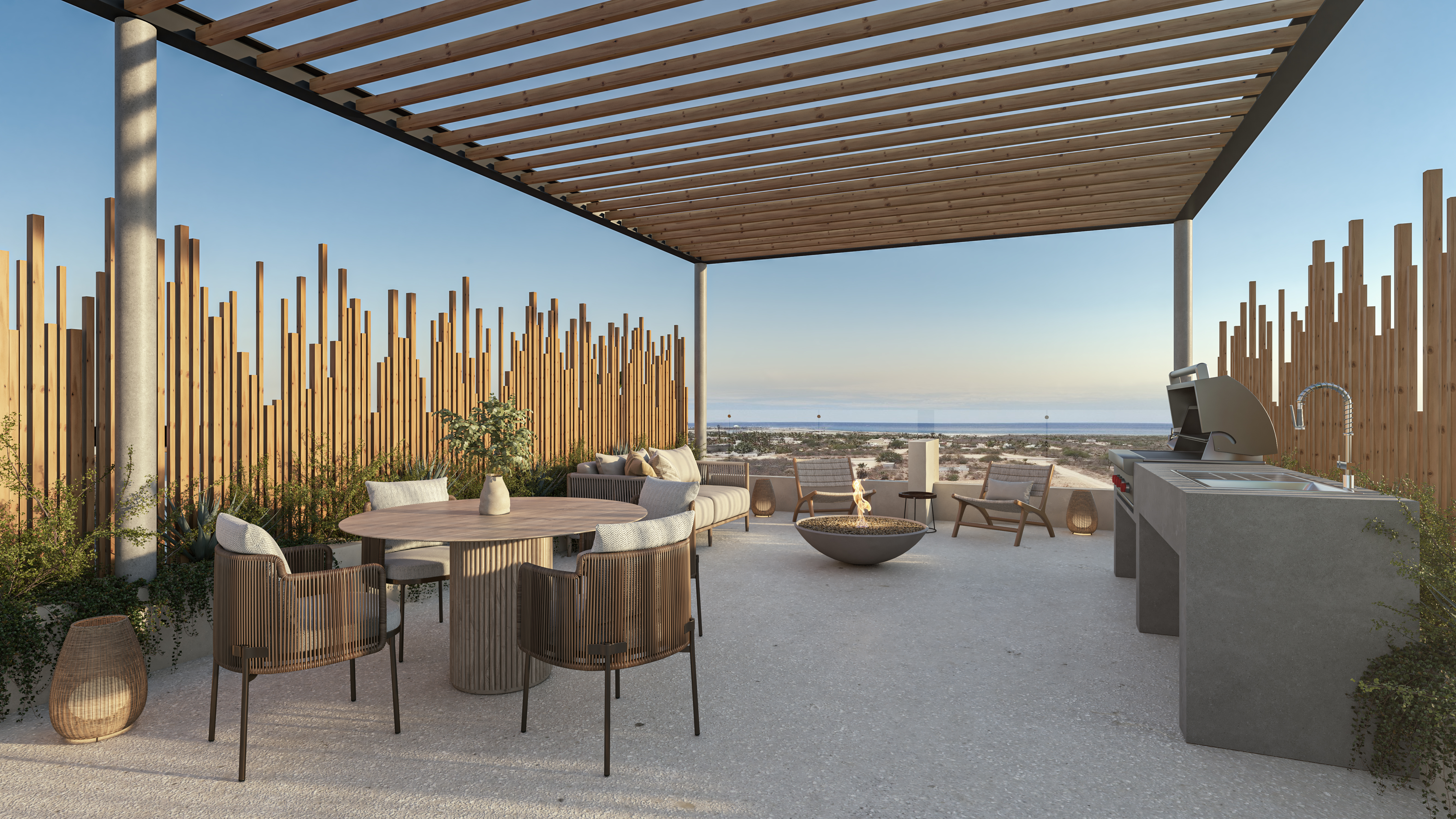 A large terrace, with a kitchen, a sink, an outdoor grill and dining table