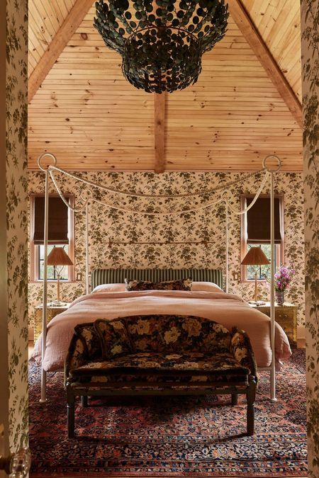 Nicole Fisher's floral primary colonial bedroom with a pine clad ceiling and four poster bed