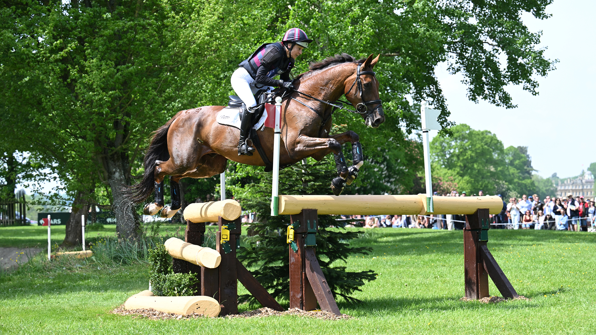 Sarah Bullimore and Corimiro, favourites among the Burghley Horse Trials entries for 2026, jump a corner fence at Badminton Horse Trials 2026. 