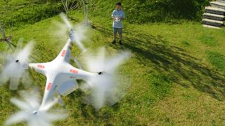 Boy flying drone in backyard