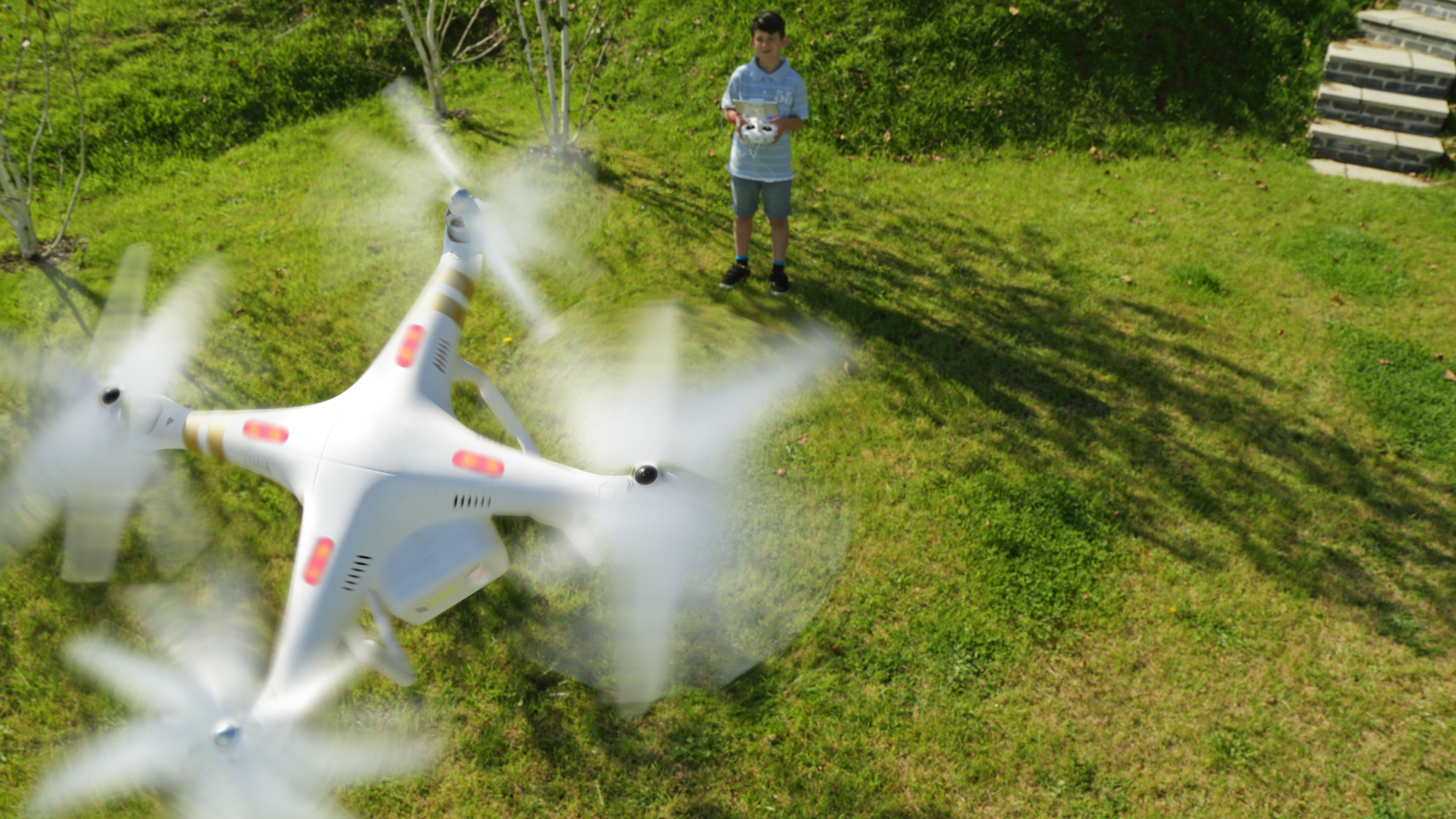Boy flying a drone in the backyard