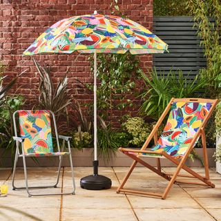 colourful chairs with colourful umbrella near trees