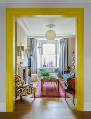 Full length curtains in a colourful living room