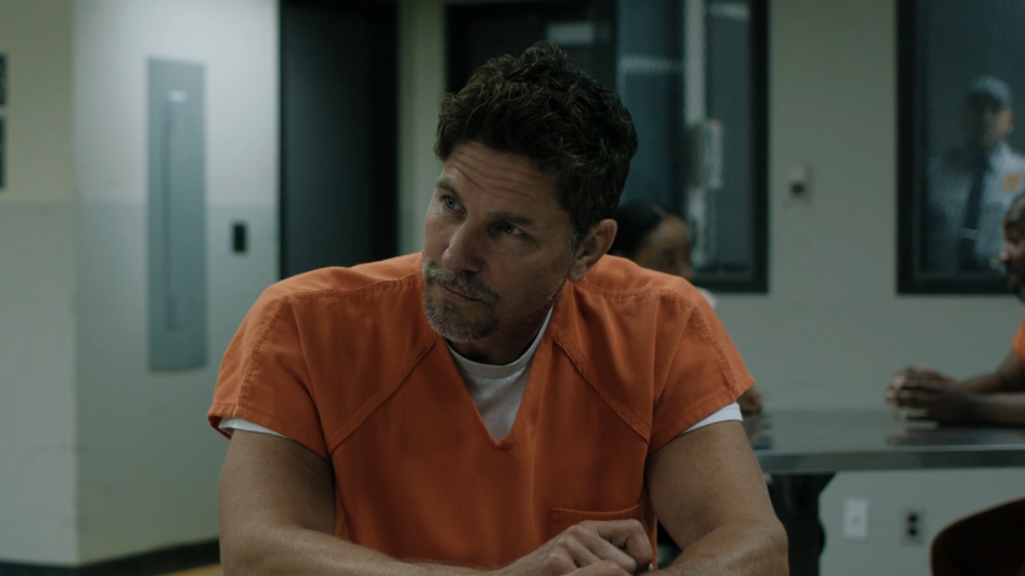 Michael Trucco wearing an orange prison uniform in Carrie Episode 7.
