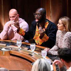 the cast of traitors season 3 sits around the round table while bob the drag queen talks passionately