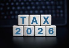 "tax 2026" on wooden blocks against a dark background