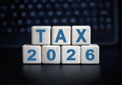 "tax 2026" on wooden blocks against a dark background