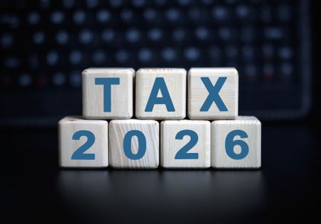 "tax 2026" on wooden blocks against a dark background