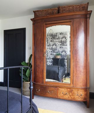 bedroom with wooden cupboard with black door