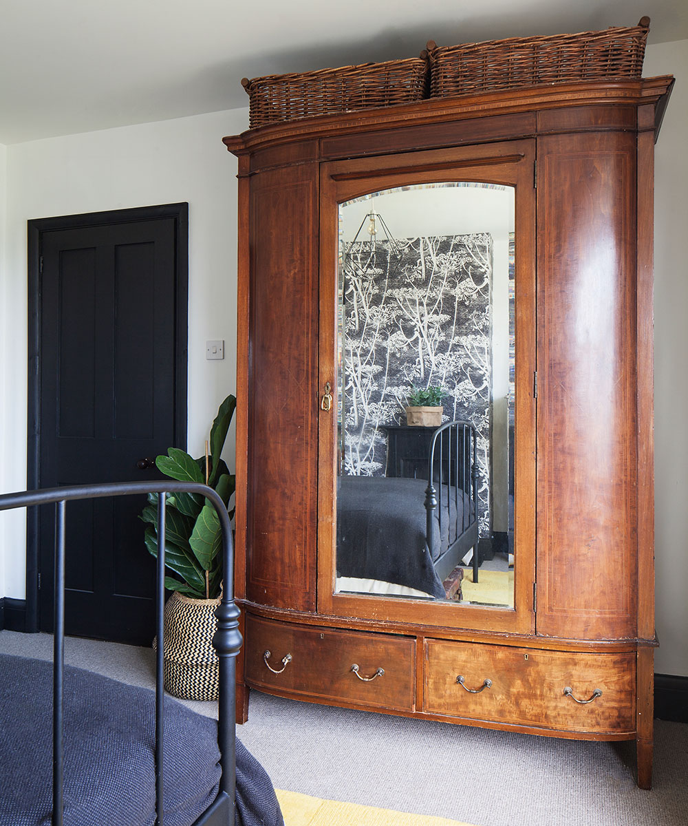bedroom with wooden cupboard with black door