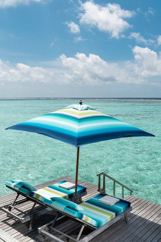 Blue missoni patterned parasol and lounger on blue sea