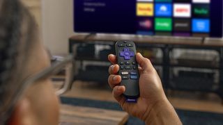 Person using Roku Streaming Stick 4K on TV