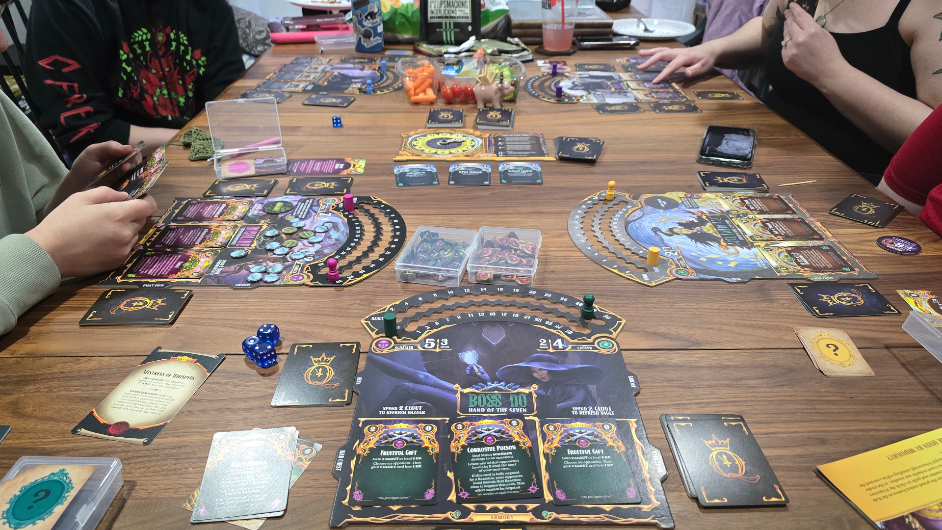 A group of gamers playing Queen by Midnight on a wooden table
