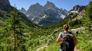 Woman looks out over Tetons wilderness