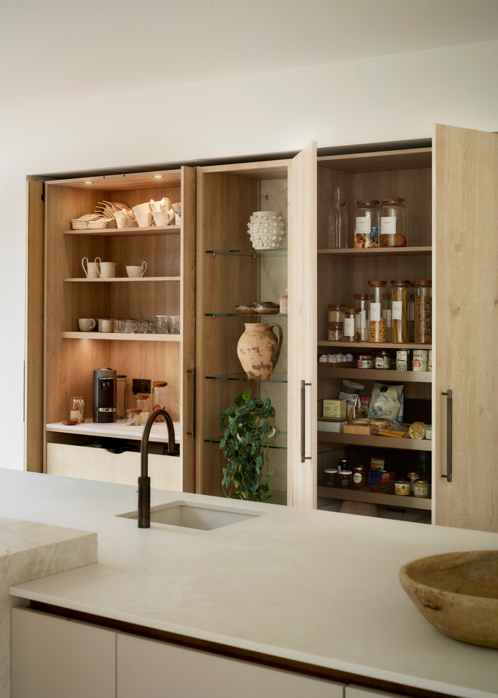 modern kitchen with wooden shelving and a pocket door