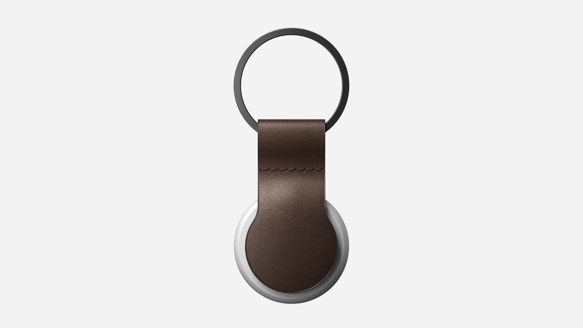 A brown leather keyring holding an AirTag