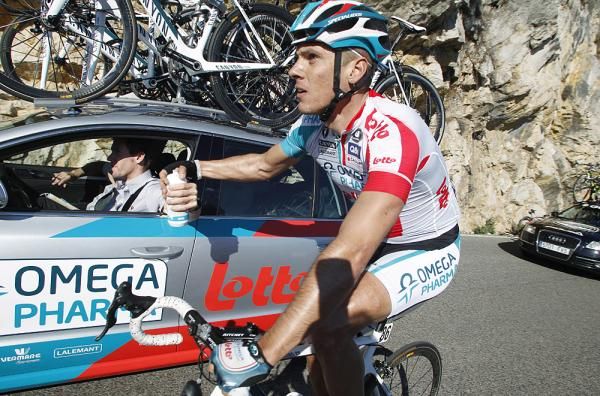 Philippel Gilbert at the Omega Pharma-Lotto car, getting water while in the breakaway