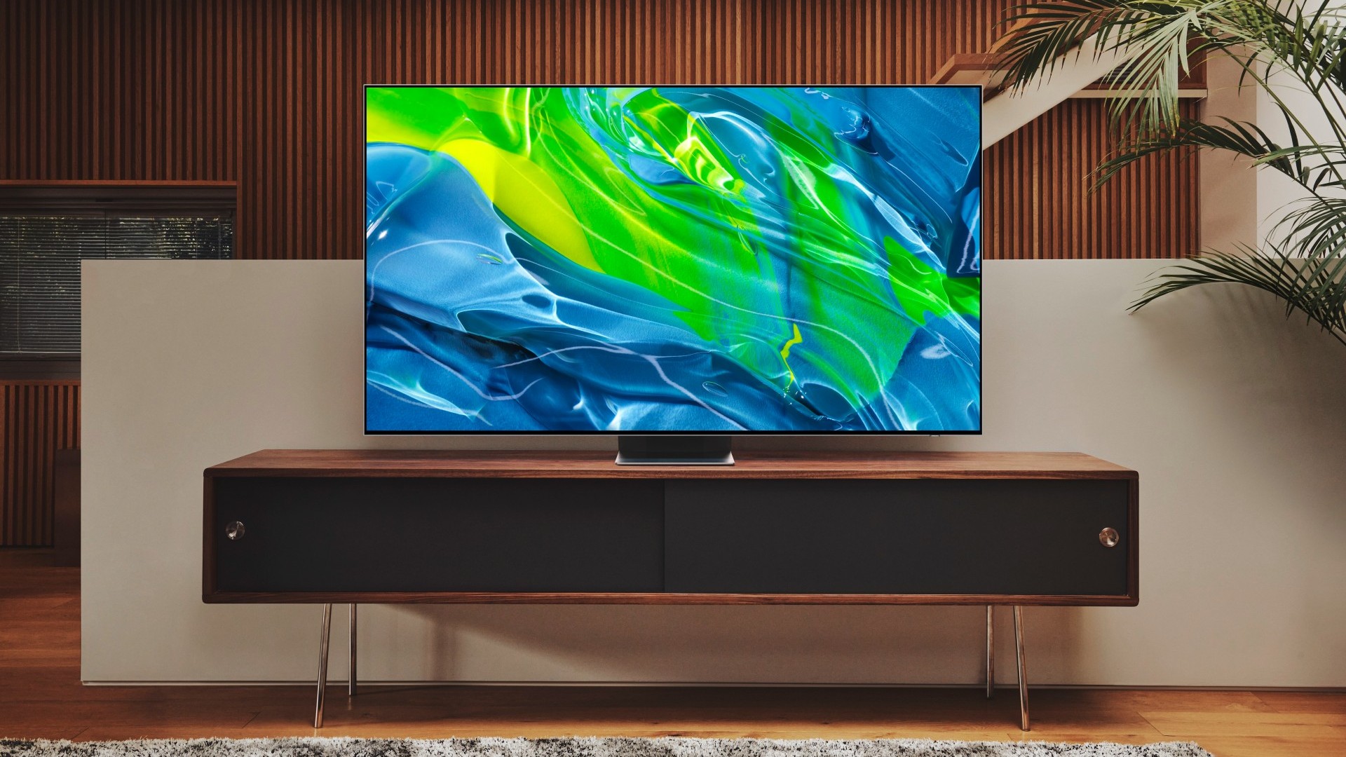 Samsung S95B OLED on a wooden TV stand