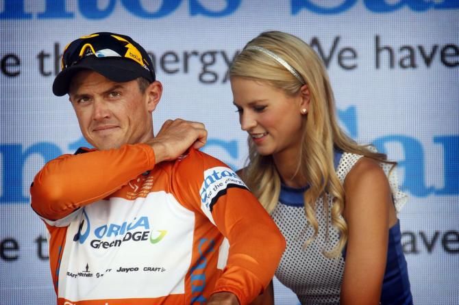 Simon Herrans pulls on the leader's ocre jersey