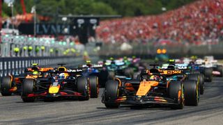 Oscar Piastri of Australia driving the (81) McLaren MCL39 Mercedes leads Max Verstappen of the Netherlands driving the (1) Oracle Red Bull Racing RB21 and the rest of the field at the start during the F1 Grand Prix of Emilia-Romagna