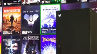 Xbox Series X in front of a TV displaying Xbox Game Pass games