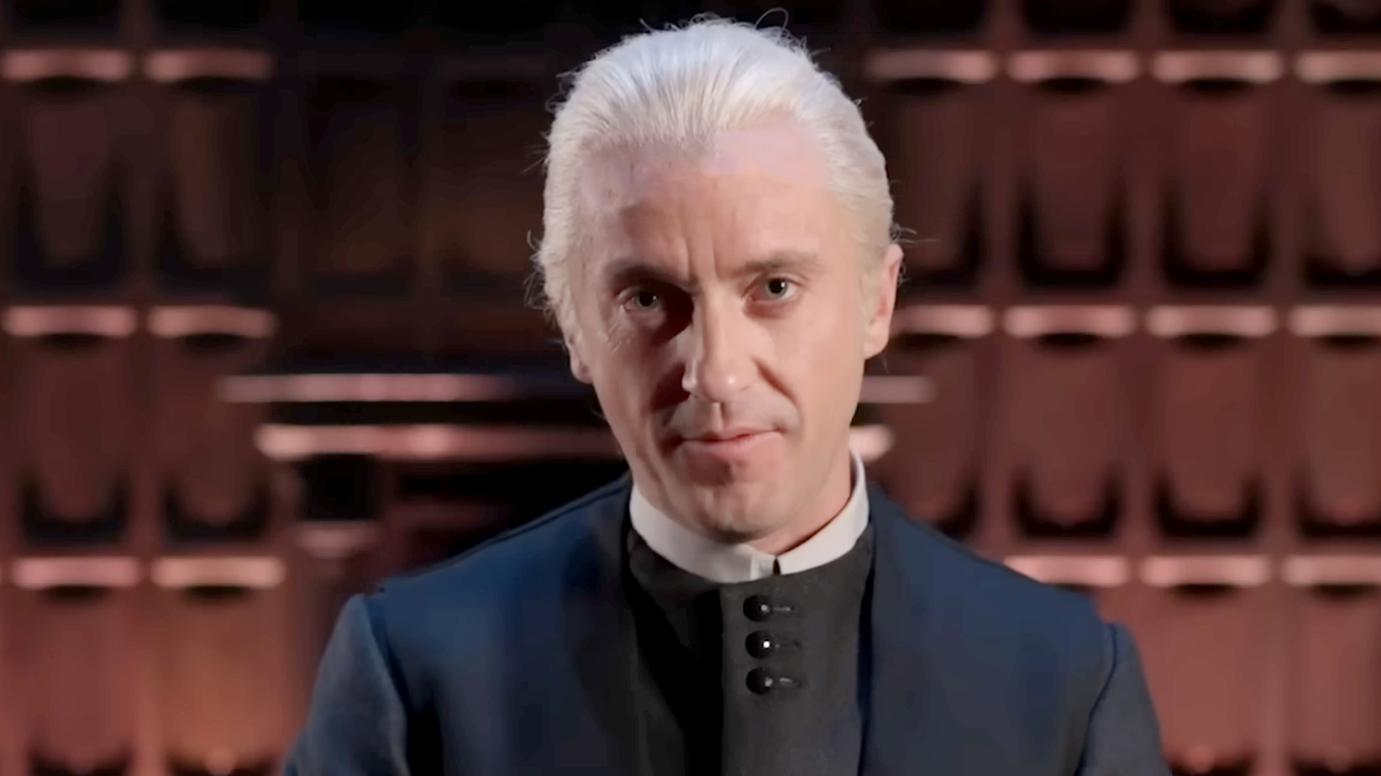Tom Felton stands in black robes and Draco Malfoy's iconic blonde hair for his run in Harry Potter and The cursed Child on Broadway.