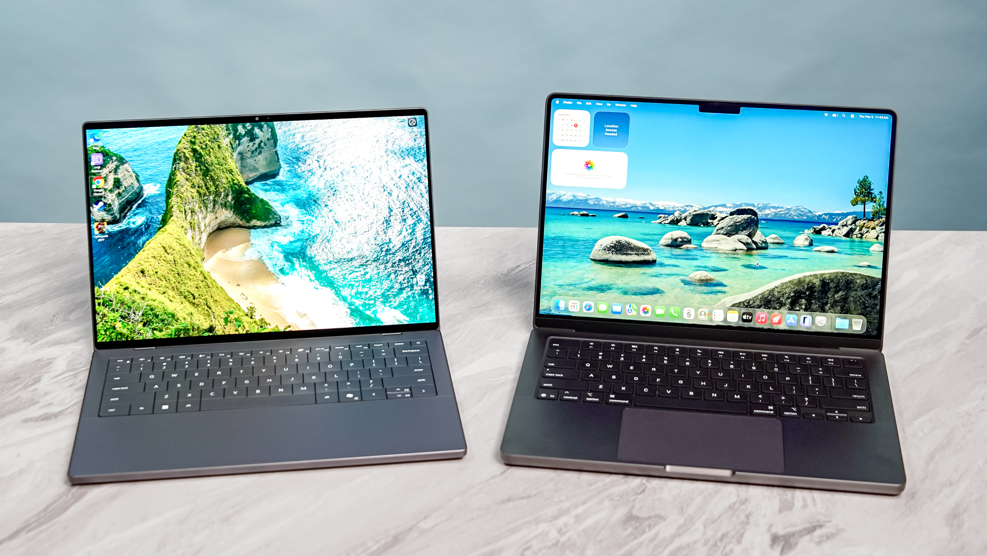Dell XPS 14 vs. MacBook Pro M5 side by side on a table.