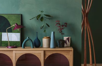 green living room wall with wooden cabinet