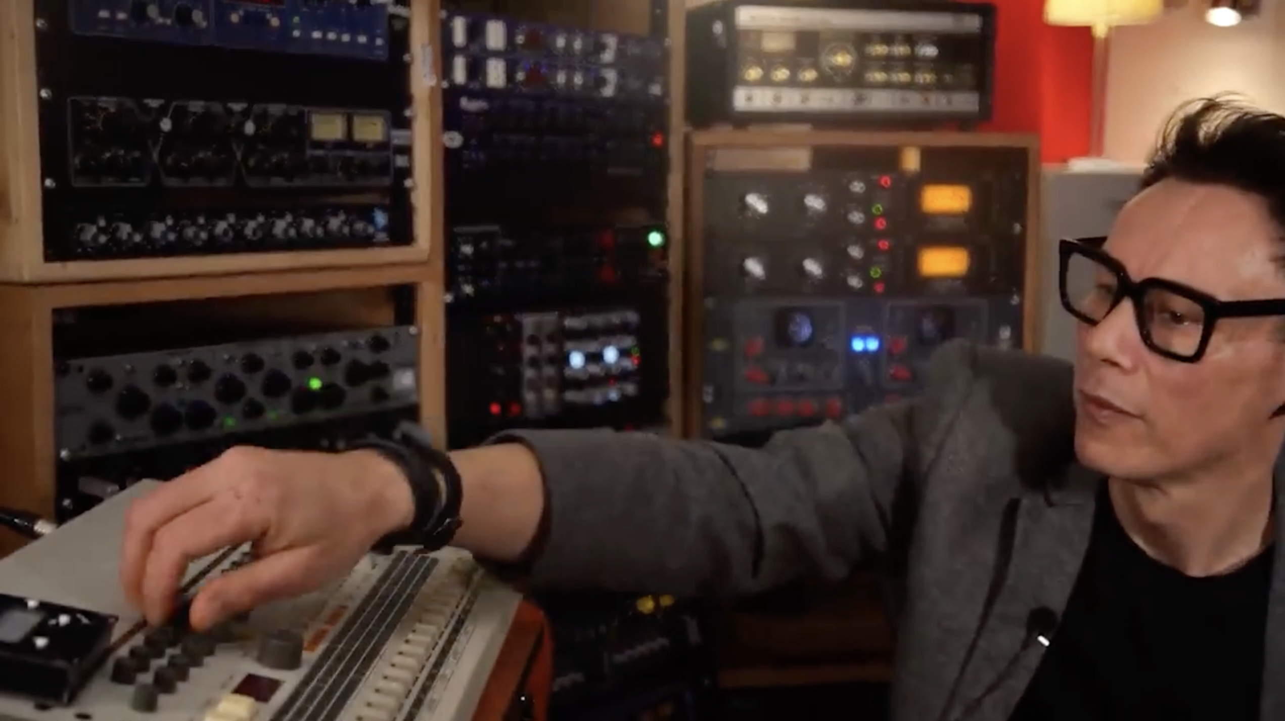 Luke Slater playing a TR-909 in the studio