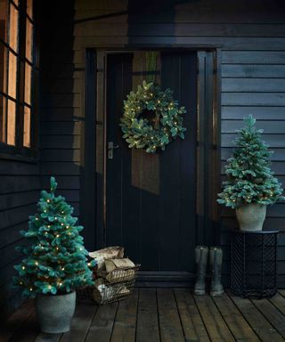porch with christmas trees and wreath