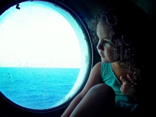 A young Uma gazes out onto the open sea in pure wonderment.