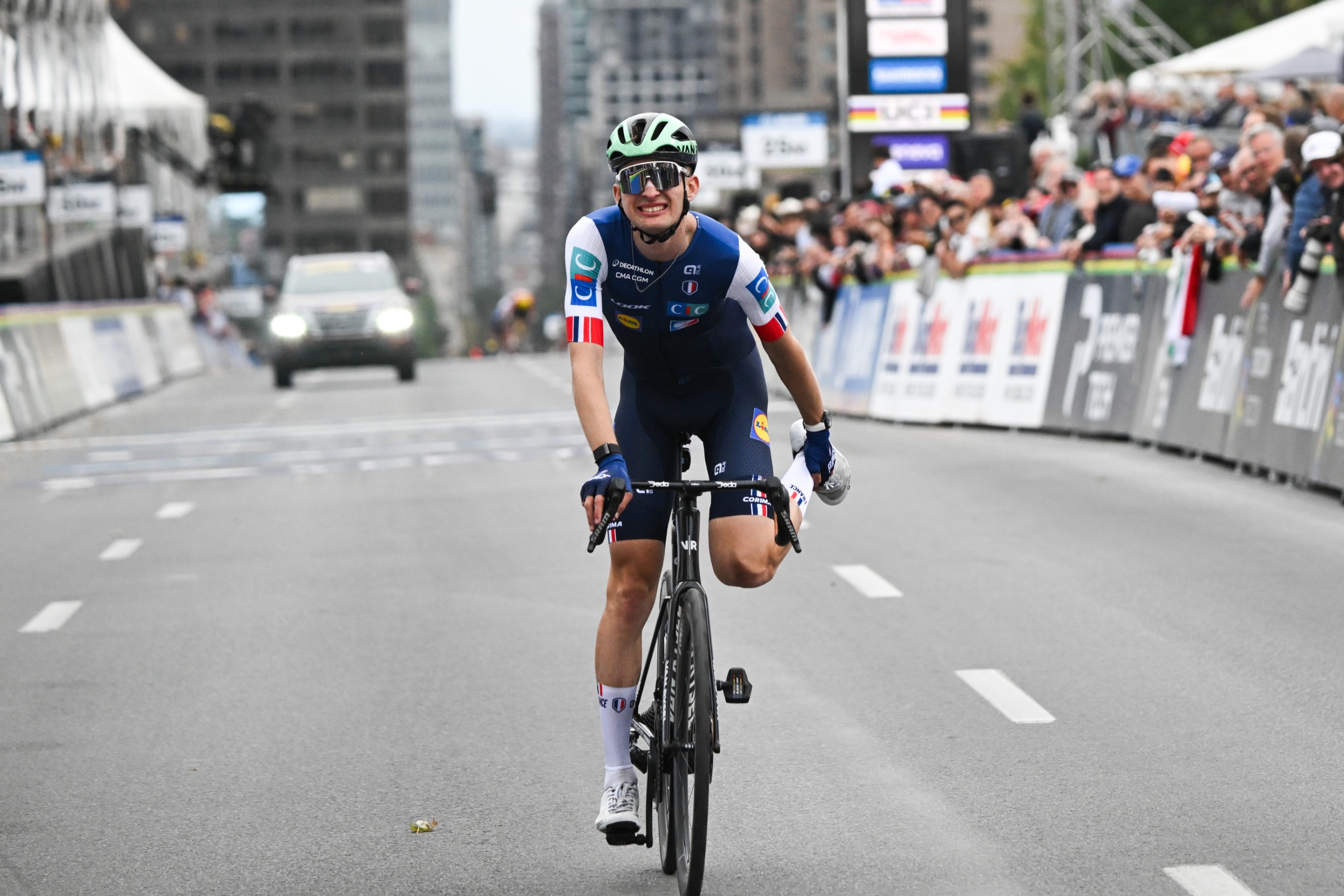 Paul Seixas stretching out his cramp after the finish line at the 2026 road world championships