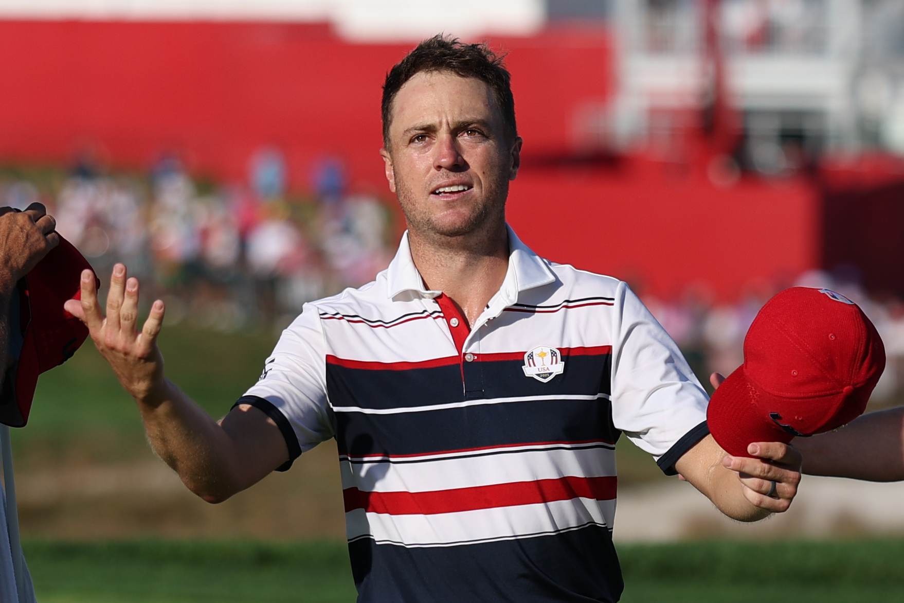 Justin Thomas celebrates to fans at the Ryder Cup
