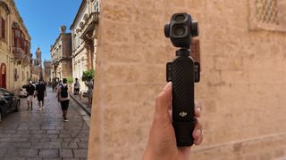 A black DJI Osmo Pocket 4P gimbal camera