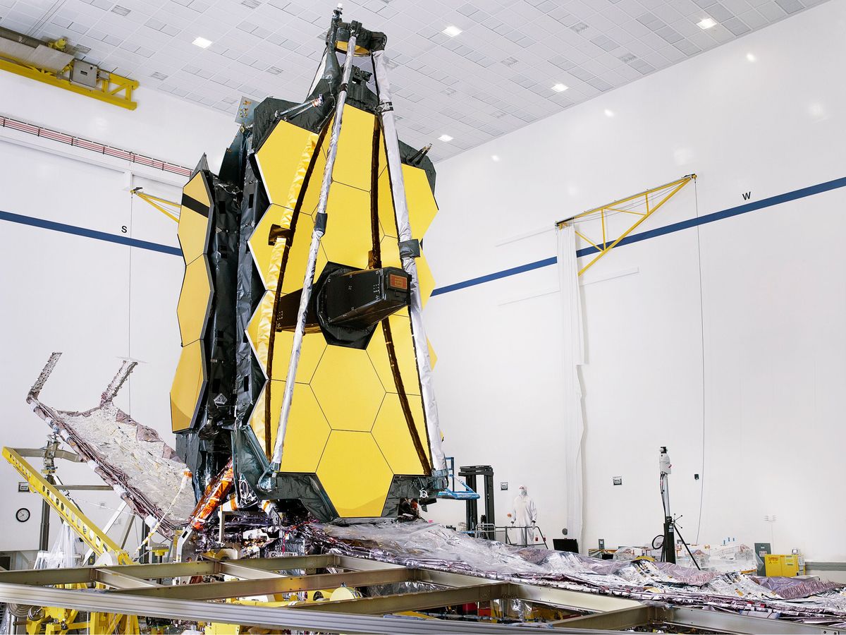 The fully assembled James Webb Space Telescope with its sunshield and “unitized pallet structures” (which fold up around the telescope for launch) are seen partially deployed to an open configuration to enable telescope installation.