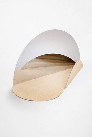 A wall-mounted shelving unit in a contemporary spiral designed shape