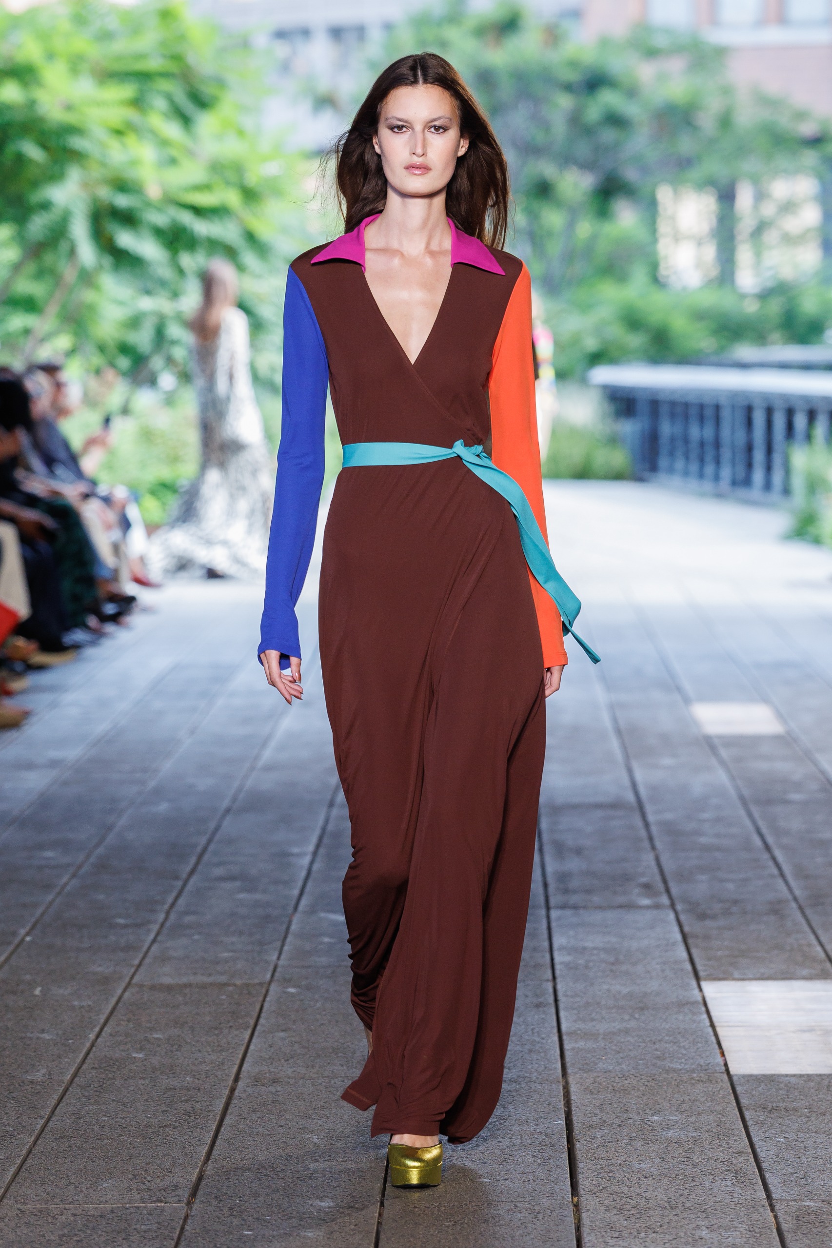 A model wearing a colorblocked wrap dress on the DVF Spring 2027 runway at New York Fashion Week.