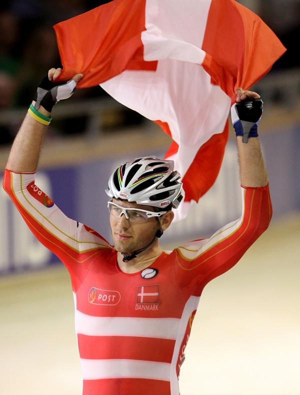 Alex Rasmussen flies the Danish flag as he celebrates his victory in the men's scratch race